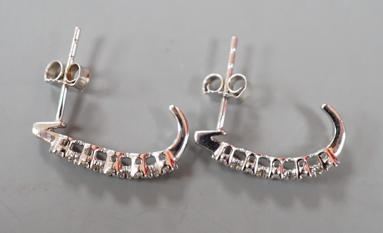 A modern pair of 375 white metal and diamond quintuple cluster set demi-lune earrings, 16mm, gross weight 1.7 grams.